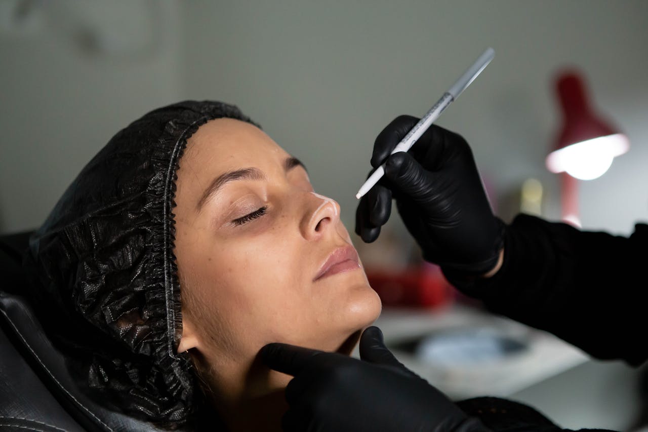 why-choose-us Beautician applies skincare treatment to woman's face with precision for enhanced beauty.