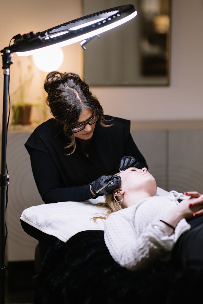 services-bg Esthetician performing professional skincare treatment in a salon setting.