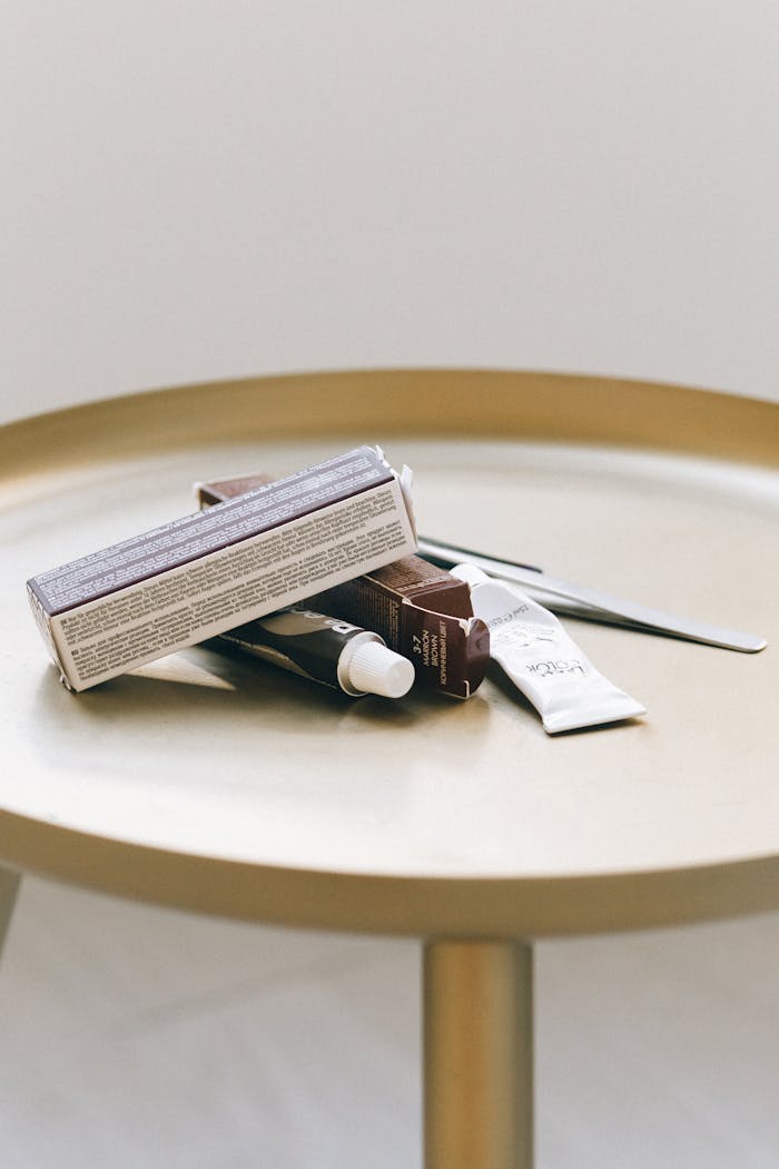 get-in-touch A collection of beauty products arranged on a minimalist round table indoors.